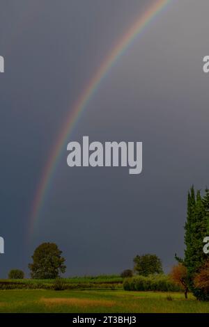 A rainbow over the Tuscan countryside in Fauglia, Pisa, Italy Stock Photo