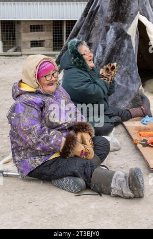 Canada, Nunavut, King William Island, Gjoa Haven. Happy community senior women in front of the Nattlik Heritage Centre. Stock Photo