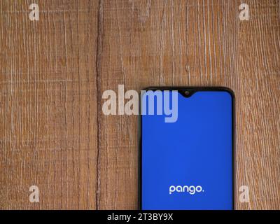 Lod, Israel - July 16,2023: Pango app launch screen on smartphone on wooden background. Top view flat lay with copy space. Stock Photo