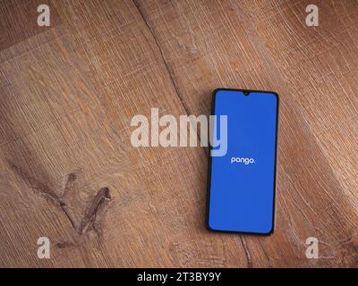 Lod, Israel - July 16,2023: Pango app launch screen on smartphone on wooden background. Top view flat lay with copy space. Stock Photo