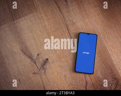 Lod, Israel - July 16,2023: Pango app launch screen on smartphone on wooden background. Top view flat lay with copy space. Stock Photo