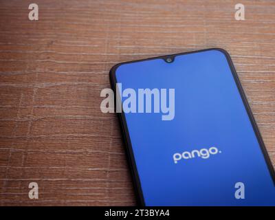 Lod, Israel - July 16,2023: Pango app launch screen on smartphone on wooden background. Top view flat lay with copy space. Stock Photo