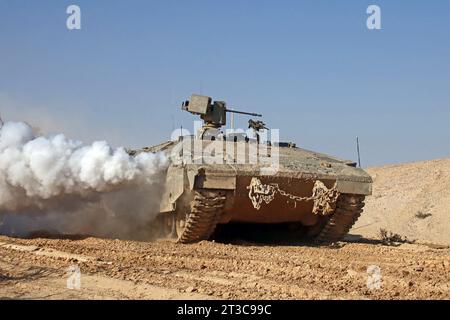 Namer APC of the Israel Defense Forces releases a smoke screen. Stock Photo