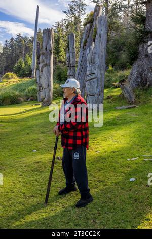 Watchman named Gordie giving tour of Totem poles at UNESCO World Heritage Site Sgang Gwaay Llnagaay, an ancient village site in Gwaii Haanas National Stock Photo