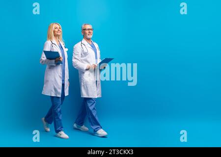 Professional medical team doctors walking towards copy space Stock Photo