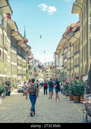 Bern, Switzerland–Aug 2,2023: Tourists walking in old town street in a sunny day Stock Photo