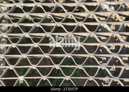 Metal industrial grade steel plate or floor grating There is a lattice drainage system. Stock Photo