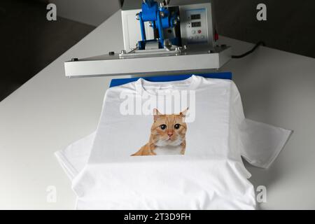 Custom t-shirt. Using heat press to print photo of cute ginger cat Stock Photo
