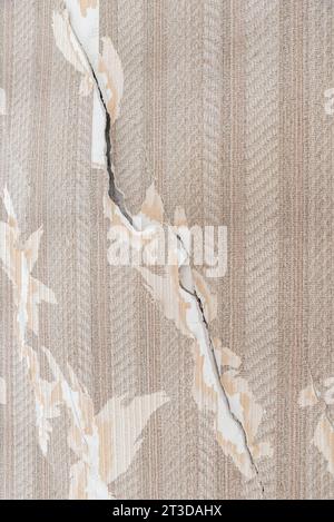 Cracks in an apartment, crack with peeling plaster on a wall Stock Photo