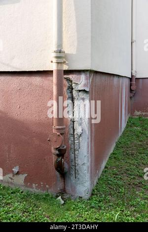 Building in poor condition. Deterioration of the basement of the facade. Stock Photo