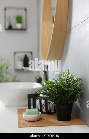 Clean towels and detergent powder on countertop in bathroom Stock Photo -  Alamy