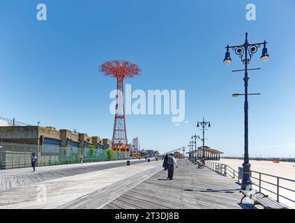 Riegelmann Boardwalk, a NYC scenic landmark, is a wood and concrete promenade stretching the length of Coney Island and Brighton Beach. Stock Photo