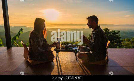 a couple on vacation in Thailand waking up with drip coffee in the morning, with a look at the mountains of Doi Chang Chiang Rai Thailand Stock Photo