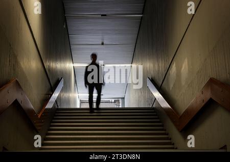 Bochum, Germany. 10th Oct, 2023. ILLUSTRATION: A man walks through the corridors of the Humanities building at the Ruhr University in Bochum. According to research by the legend researcher D. Sondermann, the building is said to be haunted. The 'Eternal Student' is haunting the brittle concrete architecture. (To dpa: 'The Eternal Student' of Bochum') Credit: Oliver Berg/dpa/Alamy Live News Stock Photo