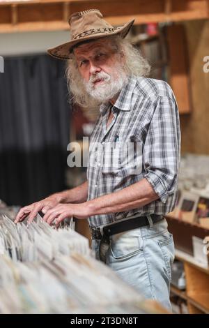 Bochum, Germany. 10th Oct, 2023. Walter Neumann, owner of a record store at the Ruhr University, talks about the 'Eternal Student' of Bochum. According to research by the legend researcher D. Sondermann, it is said to be haunted. The 'Eternal Student' haunts the brittle concrete architecture. (To dpa: 'The 'Eternal Student' of Bochum') Credit: Oliver Berg/dpa/Alamy Live News Stock Photo