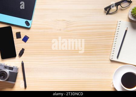 wood desk office with laptop, smartphone and other work supplies with cup of coffee. Top view with copy space for input the text. Designer workspace o Stock Photo
