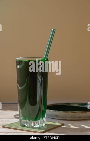 Organic blue-green algae spirulina detox drink in glass powder food. Health protein cocktail smoothie of chlorella. Vitamins and minerals to diet. Prebiotic and antioxidant rich Dietary supplement Seaweed superfood concept Stock Photo