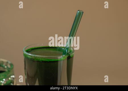 Organic blue-green algae spirulina detox drink in glass powder food. Health protein cocktail smoothie of chlorella. Vitamins and minerals to diet. Prebiotic and antioxidant rich Dietary supplement Seaweed superfood concept Stock Photo