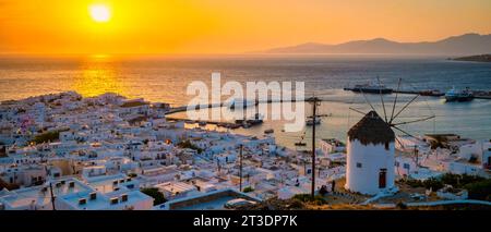 Sunset on the hills of Mykonos Greek village in Greece, the colorful old town of Mikonos village with historical windmills at sunset Stock Photo