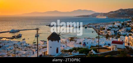 Sunset on the hills of Mykonos Greek village in Greece, the colorful old town of Mikonos village with historical windmills Stock Photo