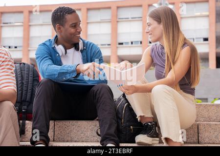 Happy students studying outdoors at the university. Stock Photo