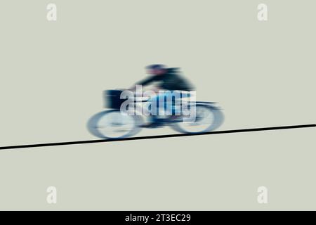 Cyclist in motion going down a slope. Abstract speed concept with a cyclist going down a line. Copy space. Stock Photo