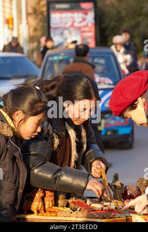 A Chinese Market Trader In The 798 Art Zone (Dashanzi Art District), Beijing, China. Stock Photo