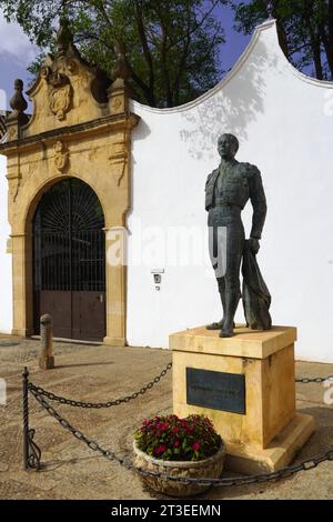 Spain, Andalusia, Ronda: Bronze statue of the matador Antonio (Cayetano) Ordonez Araujo, known as El Niño de la Palma, in front of the bullring Stock Photo