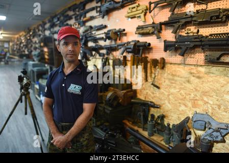 *** STRICTLY NO SALES TO FRENCH MEDIA OR PUBLISHERS - RIGHTS RESERVED ***October 01, 2023 - Taipei, Taiwan: Retired US marine staff sergeant Richard Limon poses in the small military museum attached to the Camp 66 shooting range. Limon is a shooting and weapons instructor at Camp 66. The invasion of Ukraine and the looming Chinese invasion threat have pushed some Taiwanese civilians to learn shooting as part of a grassroots civil defense movement. Real firearms being severely restricted in Taiwan, they use airsoft replicas to practice. Stock Photo