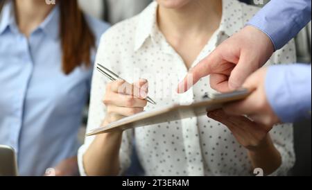 Close-up of smart people working in big modern office with smart manager. Stock Photo