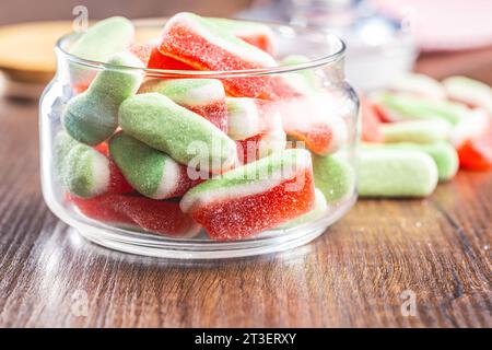 Watermelon jelly candies  in jar on the wooden table. Stock Photo