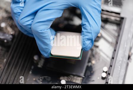 Handyman in rubber gloves installing computer processor closeup Stock Photo