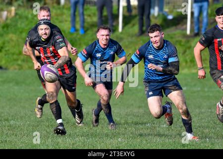 Trebanos, Wales. 21 October 2023. Rhodri Davies of Maesteg Quins and George Sheppard of Trebanos chase a loose ball during the WRU Admiral Championship West game between Trebanos and Maesteg Quins at The Park in Trebanos, Wales, UK on 21 October 2023. Credit: Duncan Thomas/Majestic Media. Stock Photo