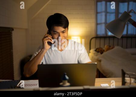 A man is working late at night. Working at night concept. Stock Photo