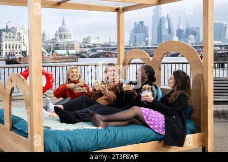 EDITORIAL USE ONLY Members of the public try out Bertinet Bakery's pop-up breakfast-in-bed experience on London's Southbank, encouraging people to make the most of an extra hour in bed as the clocks turn back this weekend. Picture date: The pop-up follows research by Bertinet Bakery which reveals the weekend 'lie-in' may have become a rarity, with 65 per cent of British people reporting to wake up before 9am on a Sunday, and 1 in 7 confessing that their lie-ins only last 29 minutes longer than their regular wake-up time. Photo credit should read: Doug Peters/PA Wire Stock Photo