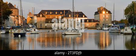 France, Finistere, Pont l'Abbe, the commercial port and the lived in bridge (le pont habité), town hall housed in the former castle in the background Stock Photo