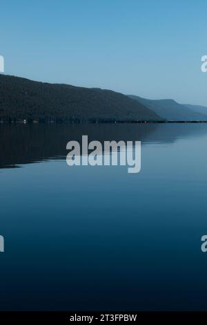 Beautiful view of a mountain and calm water with smooth surface. Stock Photo