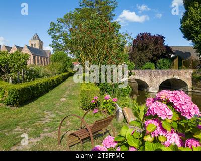 France, Nord, Esquelbecq, favorite village of the French 2023, Saint Folquin church seen from gardens of castle of Esquelbecq Stock Photo