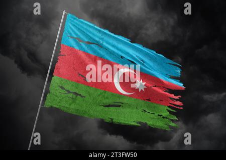 Azerbaijan torn flag on dark sky background. Stock Photo