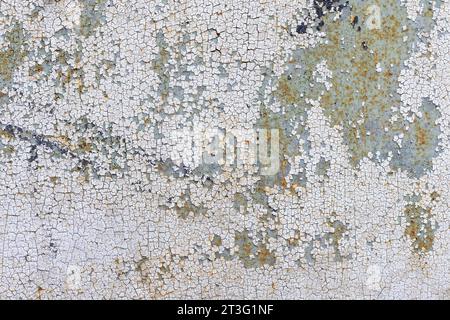 Peeling paint on the wall seamless texture with white and green grunge metal pattern. Stock Photo