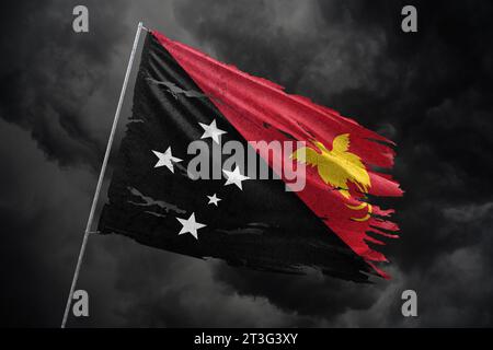 Papua New Guinea torn flag on dark sky background. Stock Photo