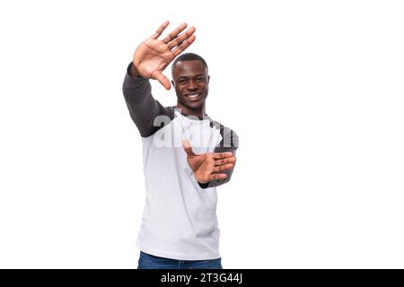 young kind handsome american man dressed in a black and white jacket with long sleeves smiling on a white background Stock Photo