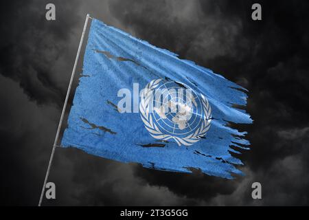 United Nations torn flag on dark sky background. Stock Photo