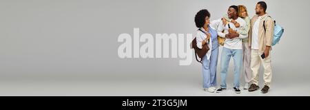 joyful young group of friends hugging and smiling at each other, student lifestyle, banner Stock Photo