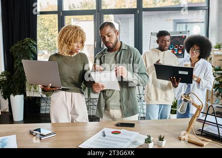 cheerful team of young friends in casual outfits joyfully discussing their project, business concept Stock Photo
