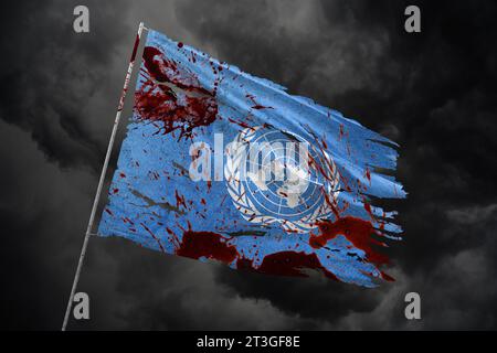 United Nations torn flag on dark sky background with blood stains. Stock Photo