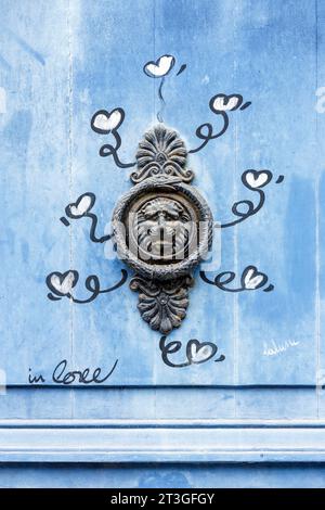 France, Charente Maritime, La Rochelle, street art based on the thema of Love and door knocker on the door of house downtown Stock Photo