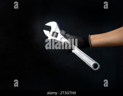 Mechanic holding a large adjustable wrench Size 375 mm Stock Photo