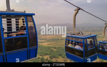 cable car of ropeway passing with amazing landscape view at day from different angle image is taken at pushkar rajasthan india on Aug 19 2023. Stock Photo