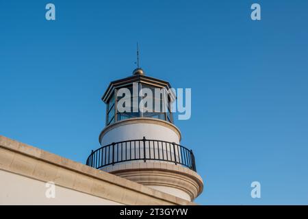 Gavdos Lighthouse, Crete island summer destination Greece. Upper part of old beacon monument surrounded by glass on blue sky background. Stock Photo
